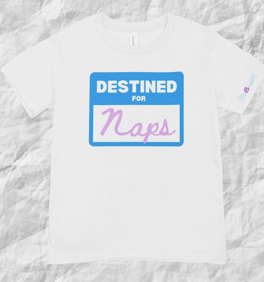 White DESTINED FOR… Tee featuring blue name tag graphic with pastel purple 'Naps' text, perfect for cozy and personalized fashion.